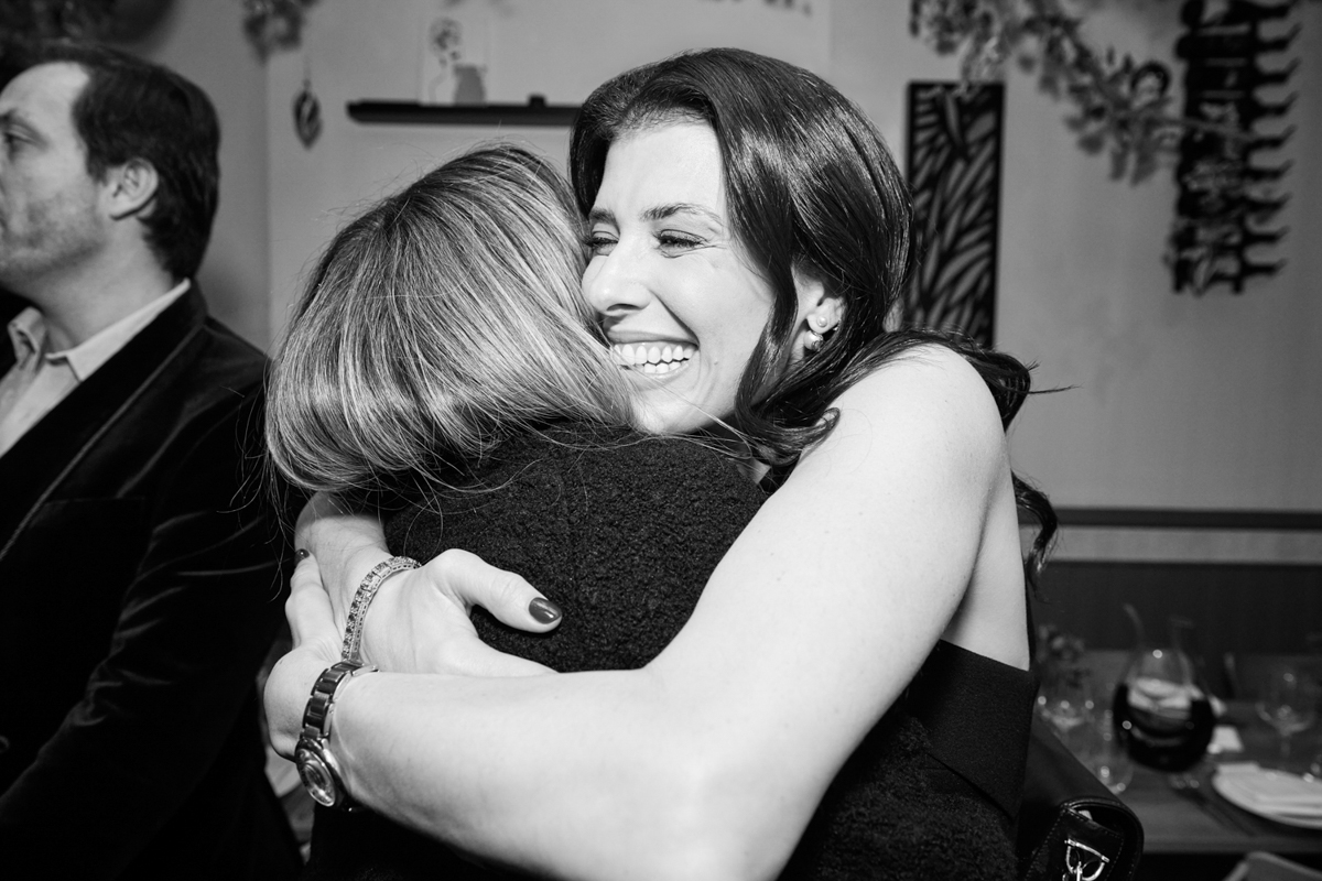 A lady hugging her friend who just arrived at her birthday dinner in London