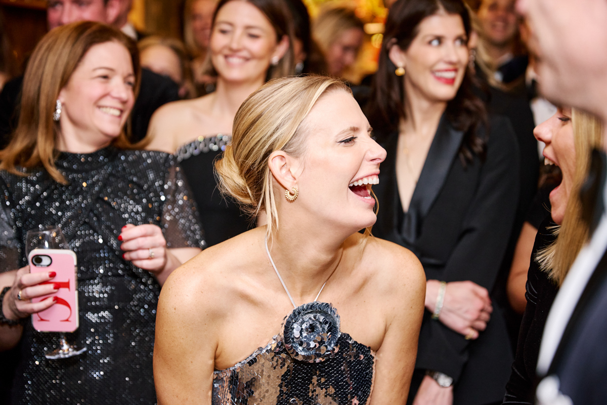 a blond lady laughing and having a good time at a venue in central London