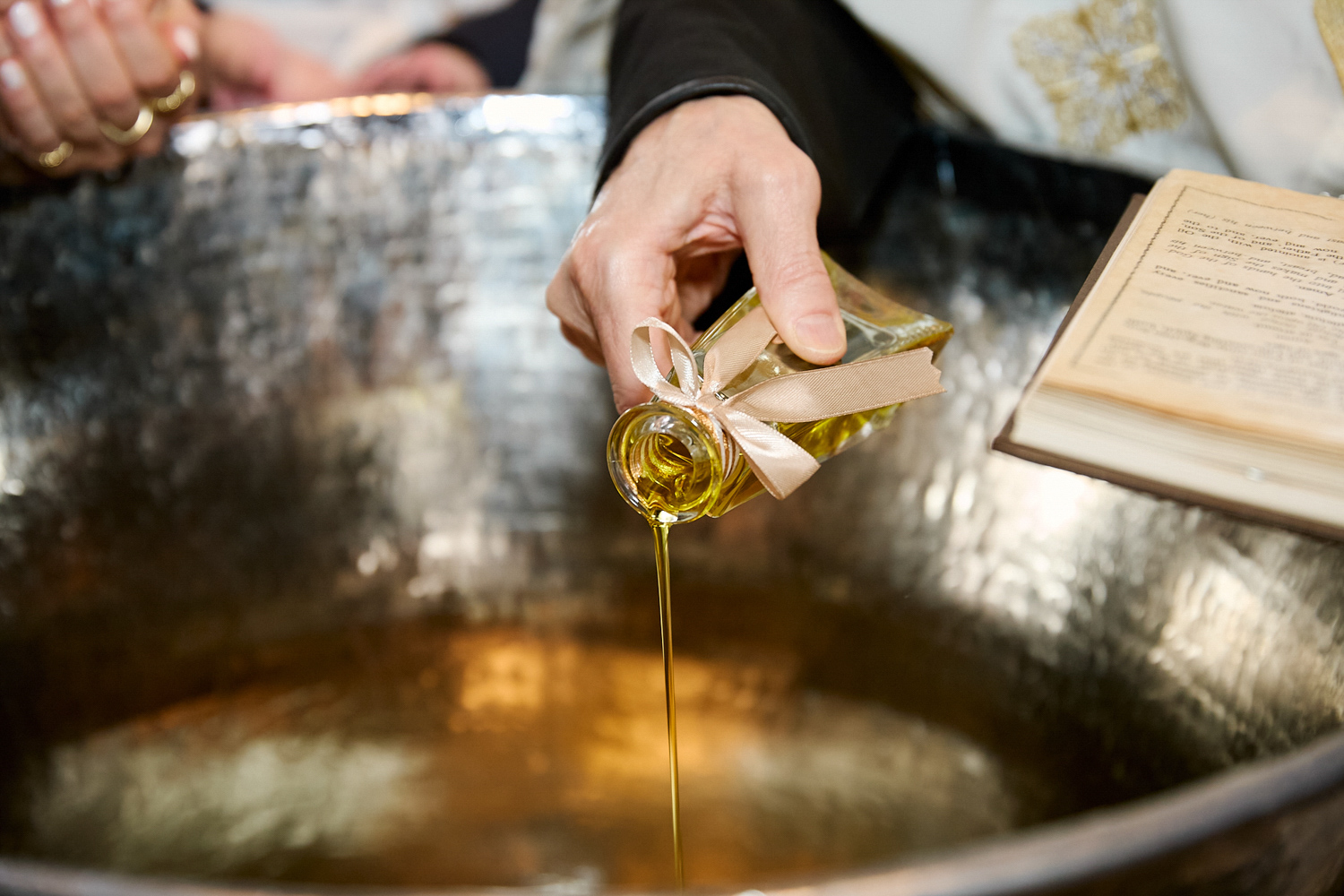 Sacred oil poured in te baptismal font.