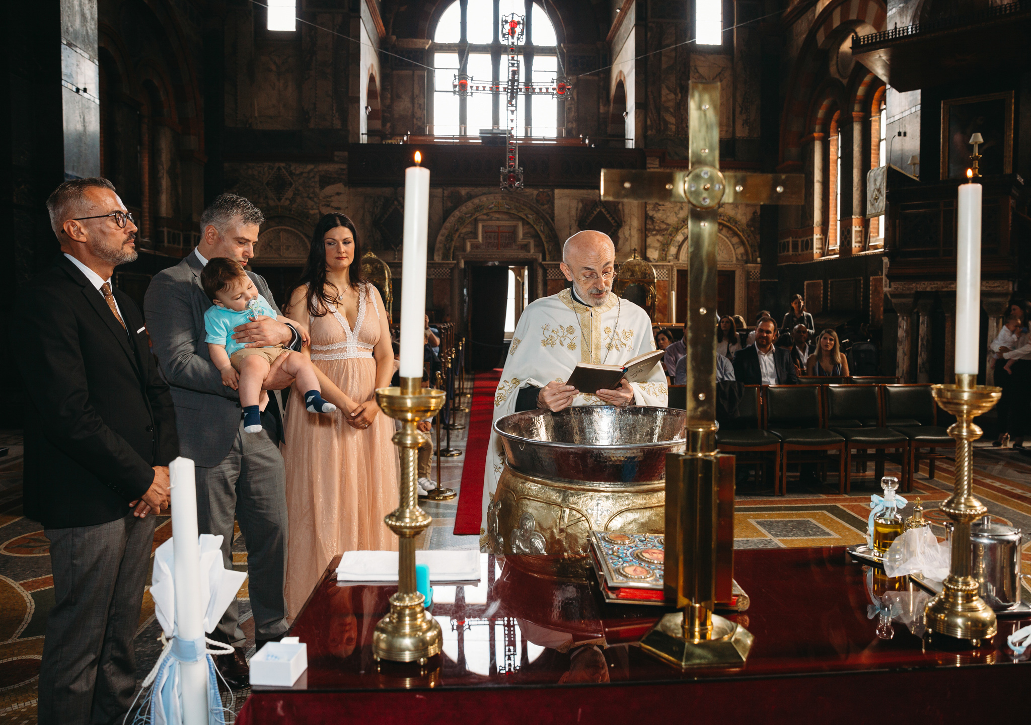 Priest reading some blessings during christening at church.