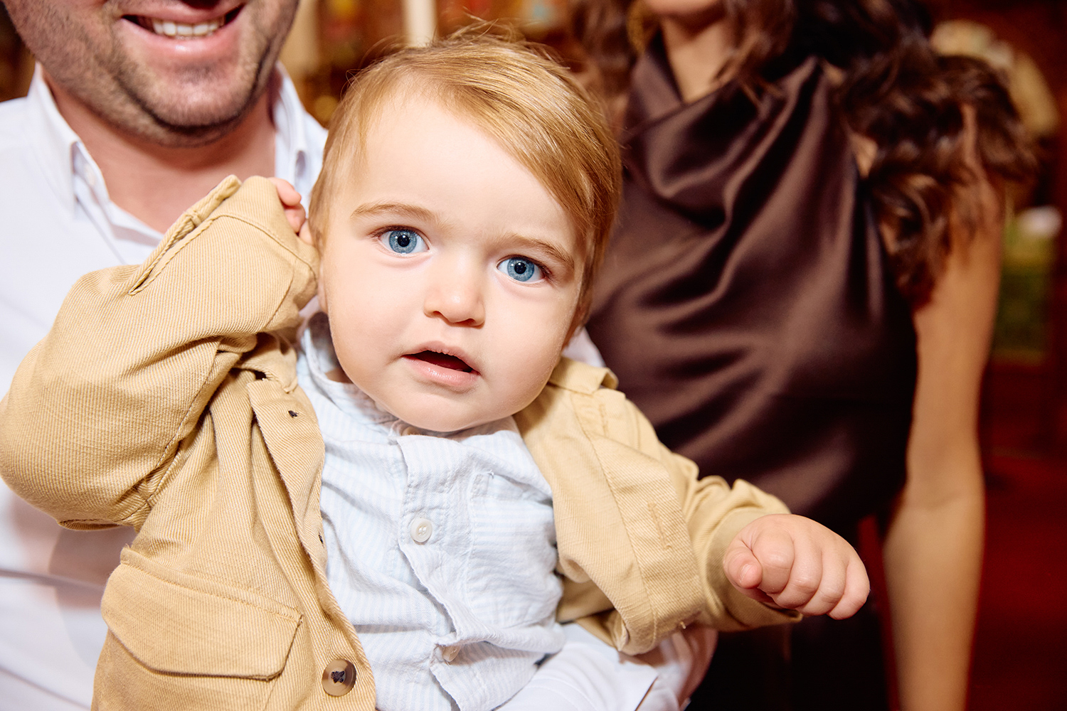 Little blond boy looking at the camera.