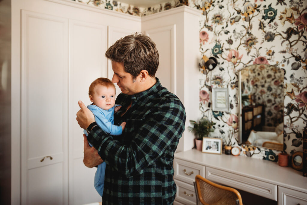 Dad holding his baby.