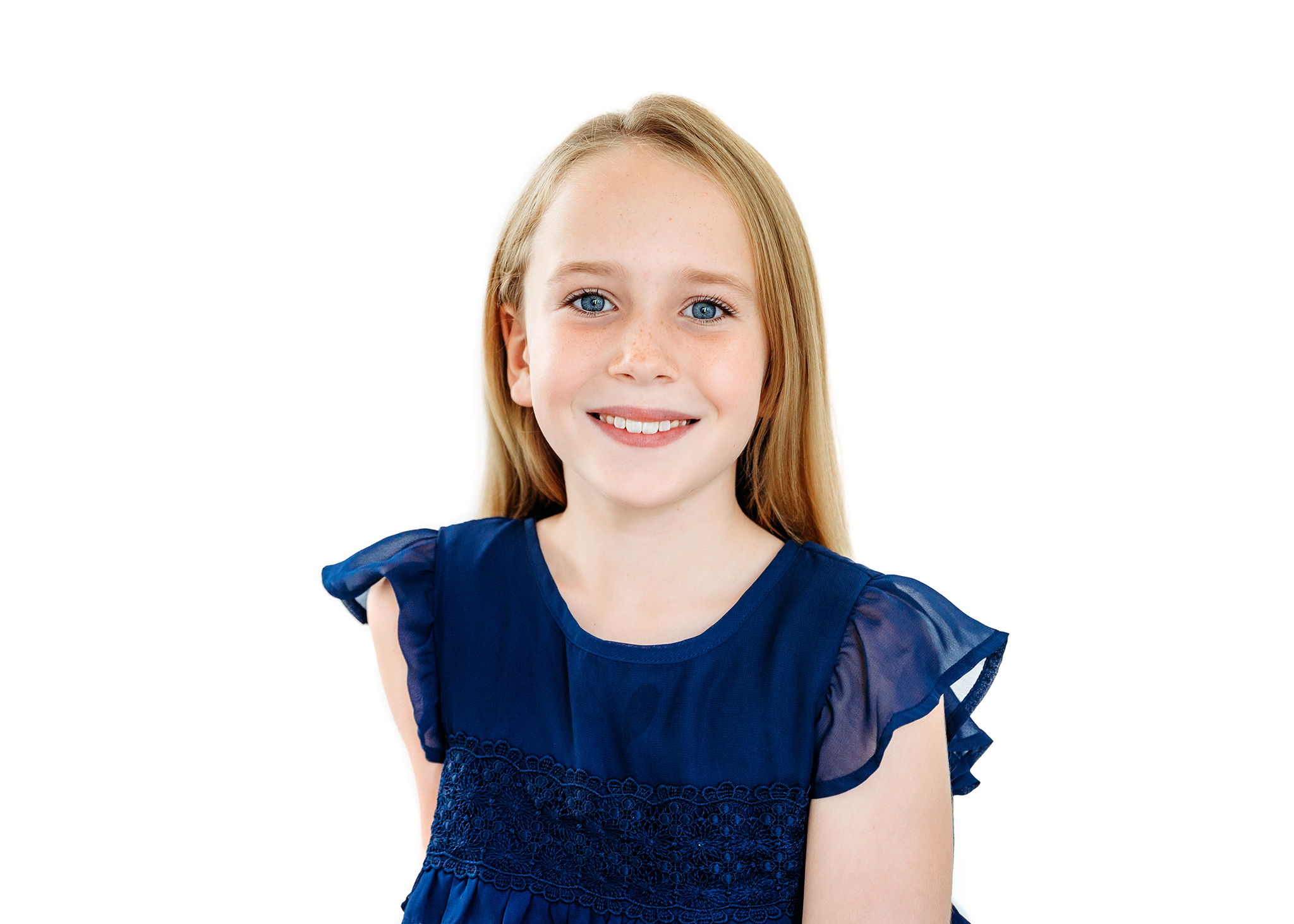 Blond girl with blue eyes and a blue top looking at the camera during a studio shoot in London.