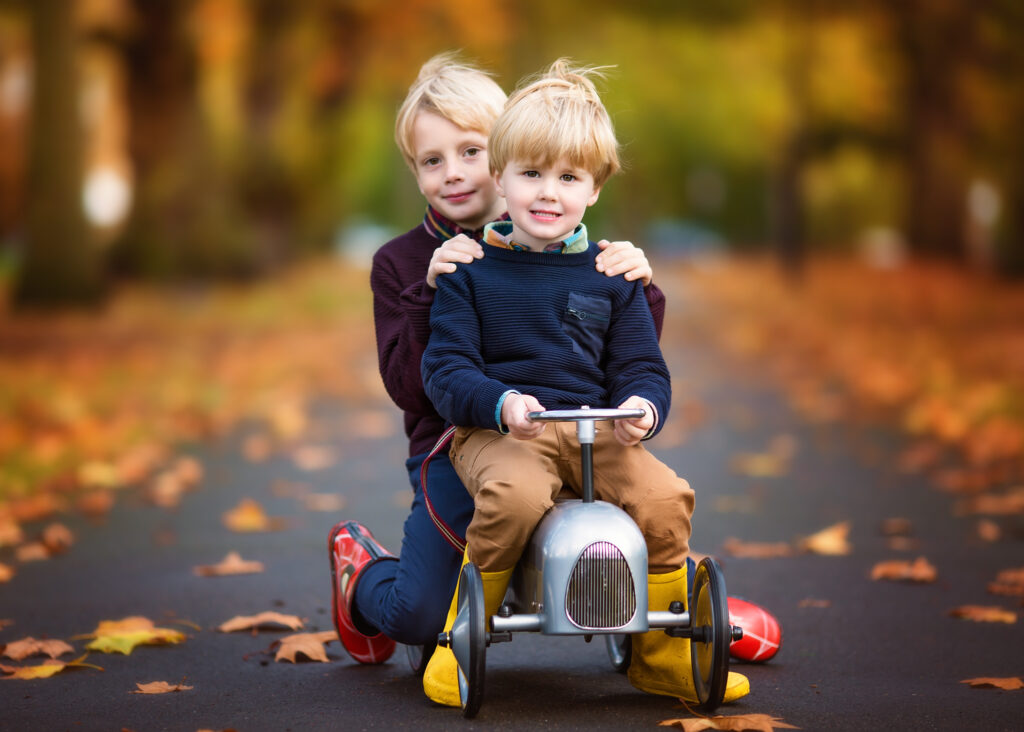 2 brothers sitting on a vintage bike in Wandsworth Common.