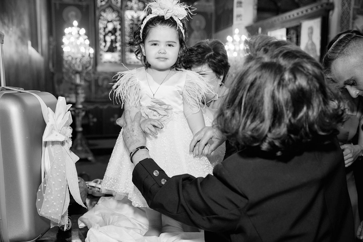 christening photographer London little girl in her christening dress inside a Greek Orthodox church